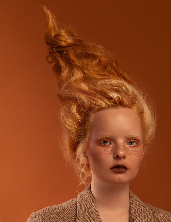 Ginger model with trendy high hairstyle for famous photography magazine's editorial